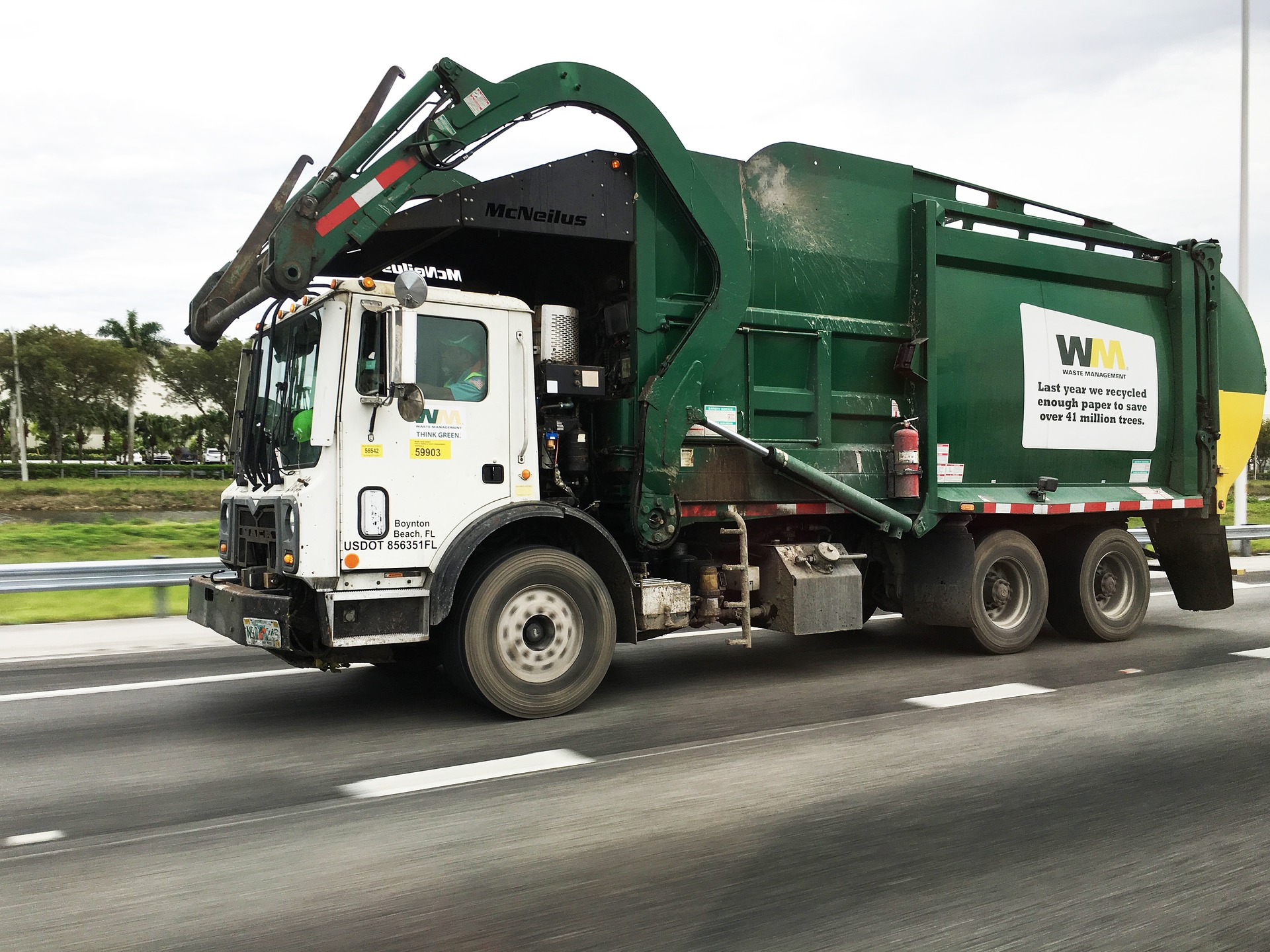 A garbage truck driving down the street.