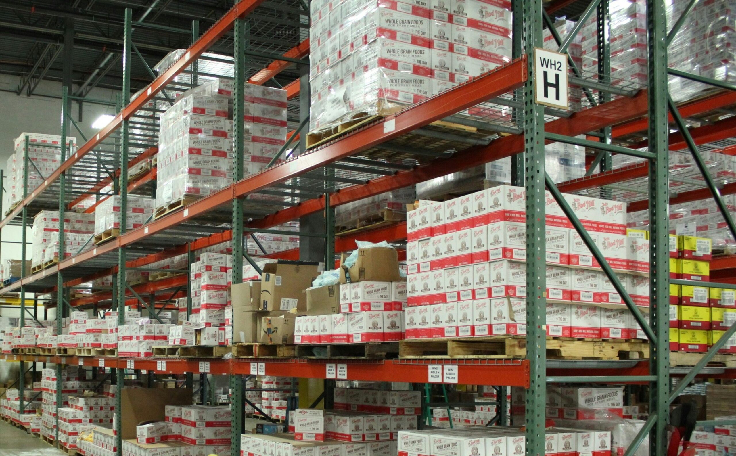 A warehouse filled with boxes of food on pallets.